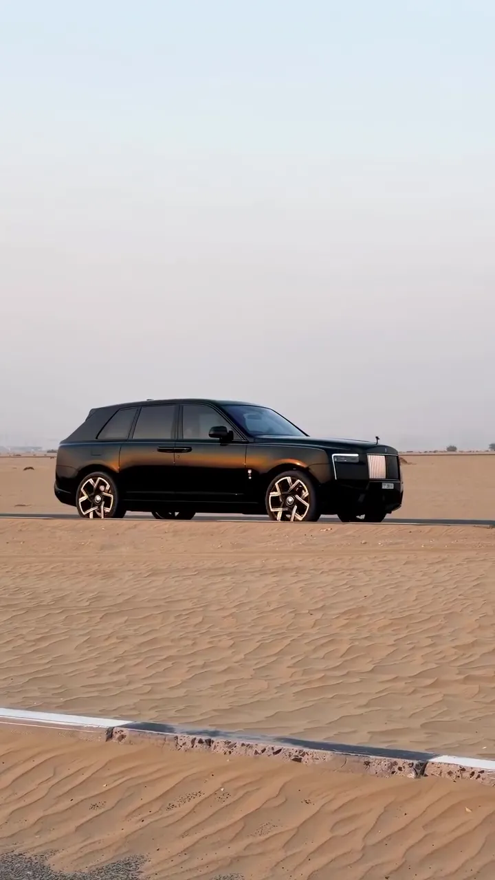 The Cullinan alone on open desert sand under a pale sky